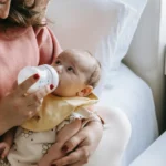Bottle-feeding your baby is a great way to ensure they get the nutrition they need, whether you’re using formula or expressed breast milk. Here’s a simple, step-by-step guide to help you bottle-feed your baby successfully. Getting Ready to Bottle-Feed Choose the Right Bottle and Nipple There are many types of bottles and nipples available. Choose one that is the right size and flow for your baby’s age and needs. Some babies prefer certain shapes or materials, so you might need to try a few before finding the perfect fit. Sterilize the Bottles Before the first use, sterilize all bottles, nipples, and any other feeding equipment. You can do this by boiling them in water for 5 minutes or using a sterilizing machine. After the first use, wash them in hot, soapy water or in the dishwasher. Prepare the Formula or Breast Milk If you’re using formula, follow the instructions on the package carefully. Use the correct amount of water and powder. If you’re using expressed breast milk, make sure it’s properly stored and warmed to body temperature. Feeding Your Baby Find a Comfortable Position Hold your baby in a semi-upright position, supporting their head. This position helps prevent choking and makes it easier for them to swallow. You can use a pillow to support your arm and make feeding more comfortable. Test the Temperature Before feeding, test the milk’s temperature by dripping a little on your wrist. It should be warm, not hot. If it’s too hot, let it cool down before giving it to your baby. Offer the Bottle Gently touch the nipple to your baby’s lips. When they open their mouth, let them latch onto the nipple. Hold the bottle at an angle so the nipple fills with milk, not air. This helps prevent your baby from swallowing air, which can cause gas. Watch for Signs of Fullness Babies will show signs when they’re full. They might turn their head away, stop sucking, or push the bottle away. Pay attention to these signs and don’t force your baby to finish the bottle. Burping Your Baby When to Burp Burp your baby during and after feeding to help release any air they’ve swallowed. This can help prevent discomfort and spitting up. How to Burp There are a few ways to burp your baby: Over Your Shoulder: Hold your baby against your shoulder and gently pat or rub their back. Sitting Up: Sit your baby on your lap, supporting their chest and head with one hand, and pat or rub their back with the other. Lying Across Your Lap: Lay your baby face down across your lap, supporting their head, and gently pat or rub their back. Cleaning Up Wash the Bottles and Nipples After each feeding, wash all bottles, nipples, and feeding equipment in hot, soapy water or in the dishwasher. Let them air dry completely before storing. Sterilize Regularly Even if you wash them after each use, it’s a good idea to sterilize bottles and nipples regularly, especially for newborns. This helps keep them free from harmful bacteria. Tips for Successful Bottle-Feeding Hold Your Baby Close Bottle-feeding is a great time to bond with your baby. Hold them close, make eye contact, and talk to them softly. This helps them feel safe and loved. Follow Your Baby’s Cues Pay attention to your baby’s hunger and fullness cues. Feed them when they show signs of hunger and stop when they’re full. This helps them develop healthy eating habits. Keep Track of Feedings Keep a record of how much and how often your baby eats. This can help you notice any changes in their feeding patterns and ensure they’re getting enough nutrition. Stay Calm and Patient Bottle-feeding can take some time, especially at first. Stay calm and patient, and don’t rush the process. Your baby will sense your calmness and feel more relaxed. When to Ask for Help Talk to Your Pediatrician If you have any concerns about your baby’s feeding, growth, or health, don’t hesitate to talk to your pediatrician. They can provide guidance and support. Seek Support from Others Don’t be afraid to ask for help from family, friends, or a lactation consultant if you’re having trouble with bottle-feeding. They can offer valuable advice and encouragement. Conclusion Bottle-feeding your baby can be a rewarding experience for both of you. By following these steps and tips, you can ensure your baby gets the nutrition they need while enjoying the special time you share during feedings. Remember, every baby is different, so find what works best for you and your little one.